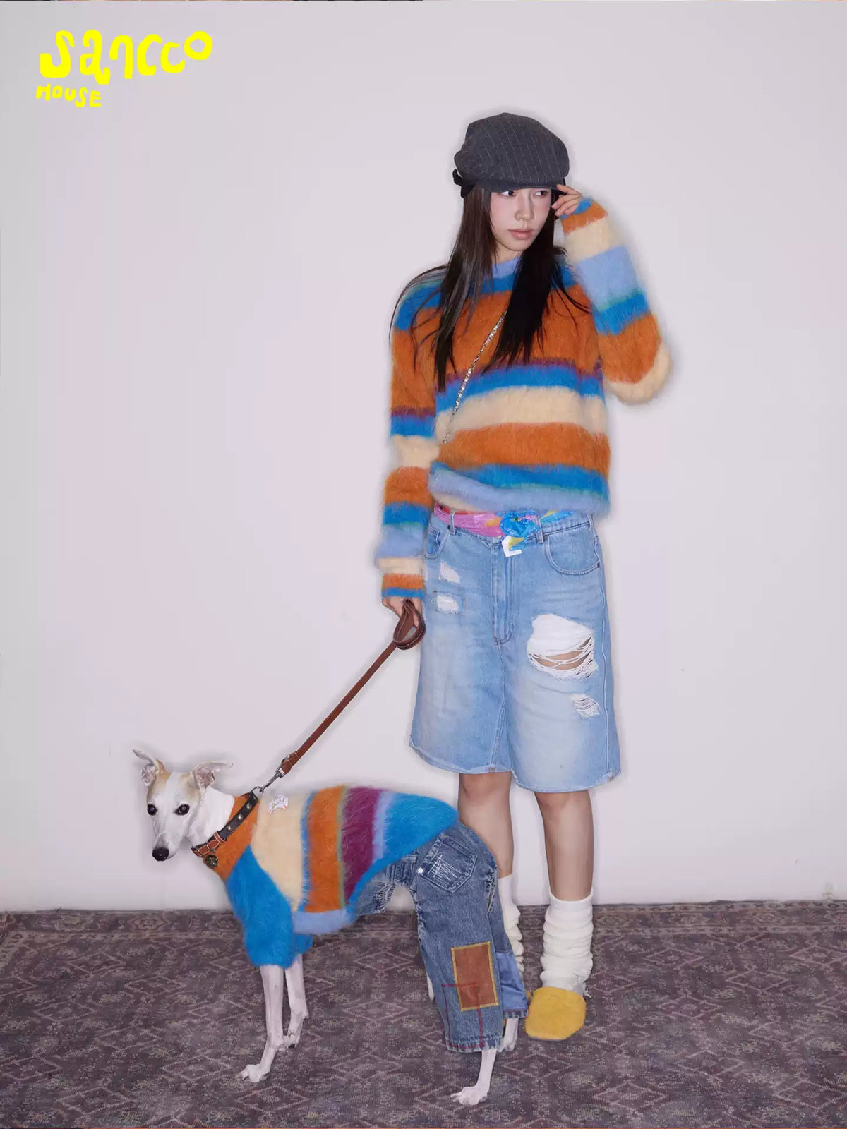 Woman standing in the sweater with her dog