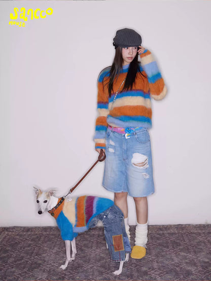 Woman standing in the sweater with her dog