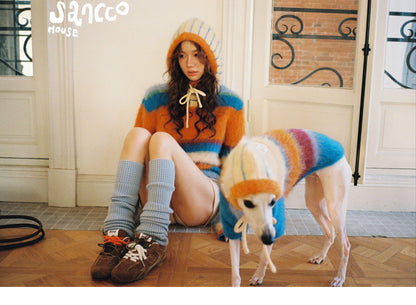 Woman and dog resting on the floor in matching hats