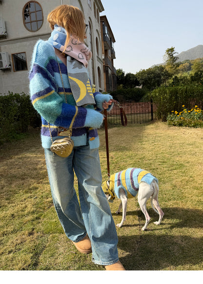 Owner wearing the scarf around the neck while walking a whippet in a striped sweater