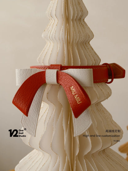 Red bows tied on a pale tree sculpture