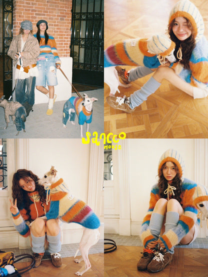 Parent kneeling beside a dog in the matching alpaca sweater