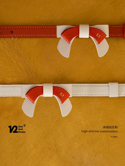 Red bow collar folded on a gold box